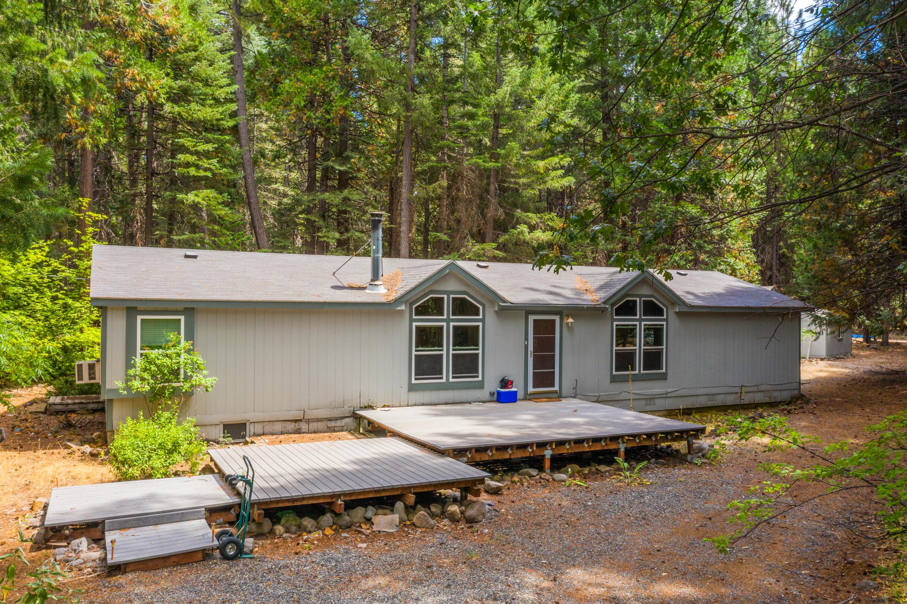 a view of a house with pool and chairs