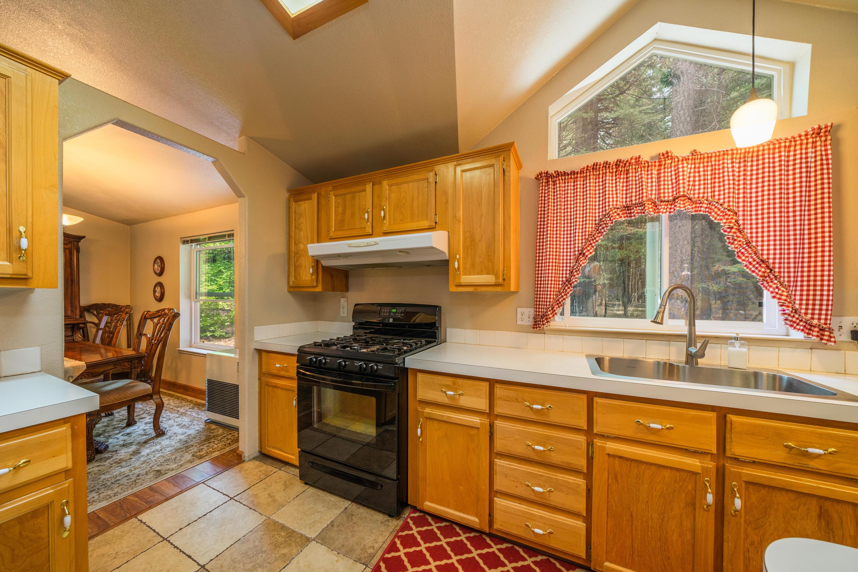 34739 Timber Ridge Road Shingletown, CA 96088 - Photo 13 of 26 a kitchen with stainless steel appliances granite countertop a stove a sink and a microwave