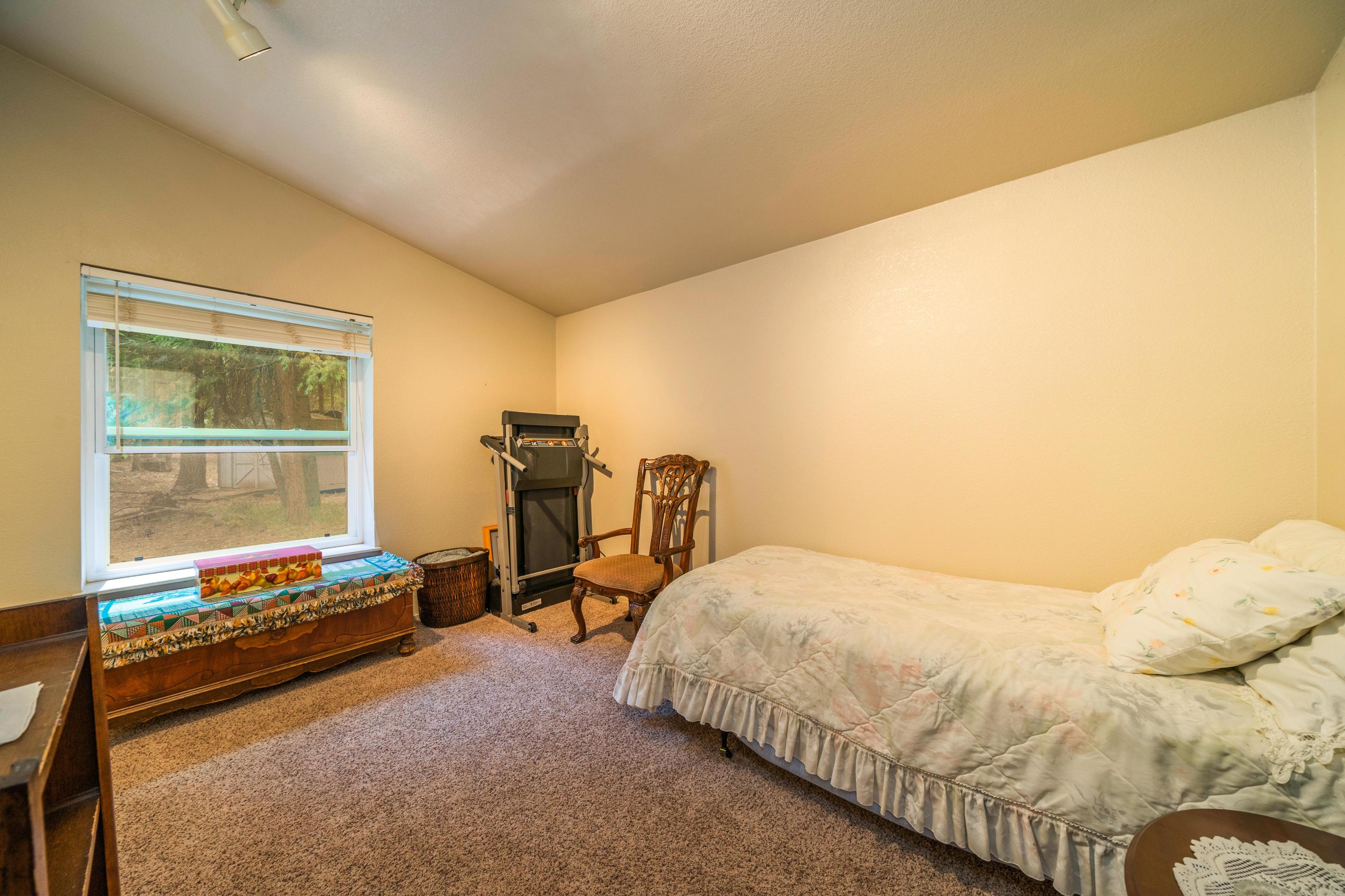 34739 Timber Ridge Road Shingletown, CA 96088 - Photo 16 of 26 a bedroom with a bed and a desk