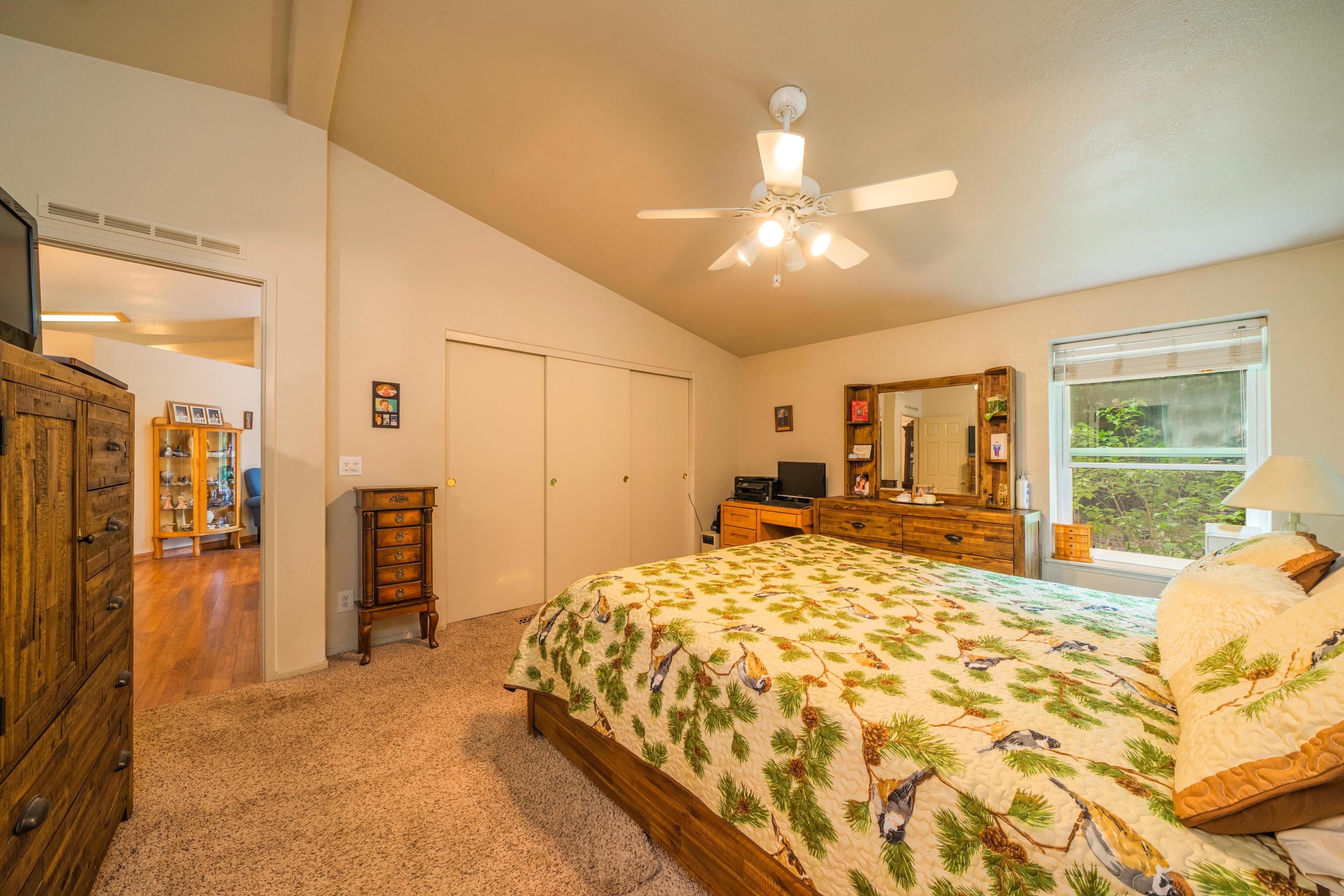34739 Timber Ridge Road Shingletown, CA 96088 - Photo 18 of 26 a bed sitting in a spacious bedroom next to a window