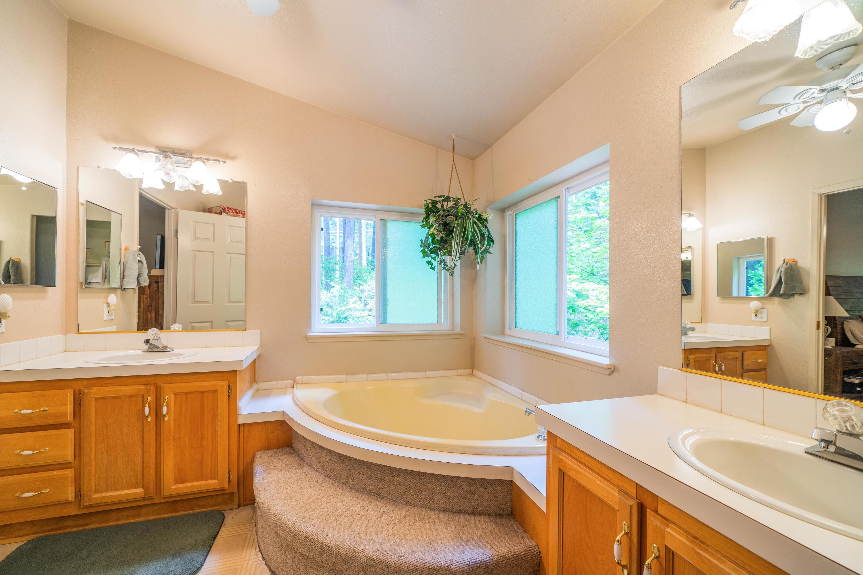 34739 Timber Ridge Road Shingletown, CA 96088 - Photo 19 of 26 a bathroom with a granite countertop sink and a bathtub