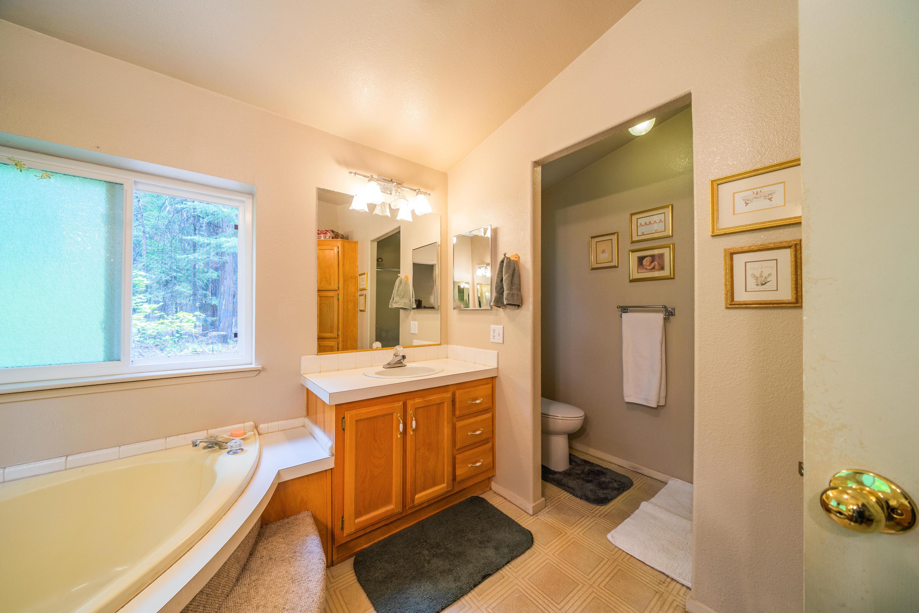 34739 Timber Ridge Road Shingletown, CA 96088 - Photo 20 of 26 a bathroom with a tub sink and toilet