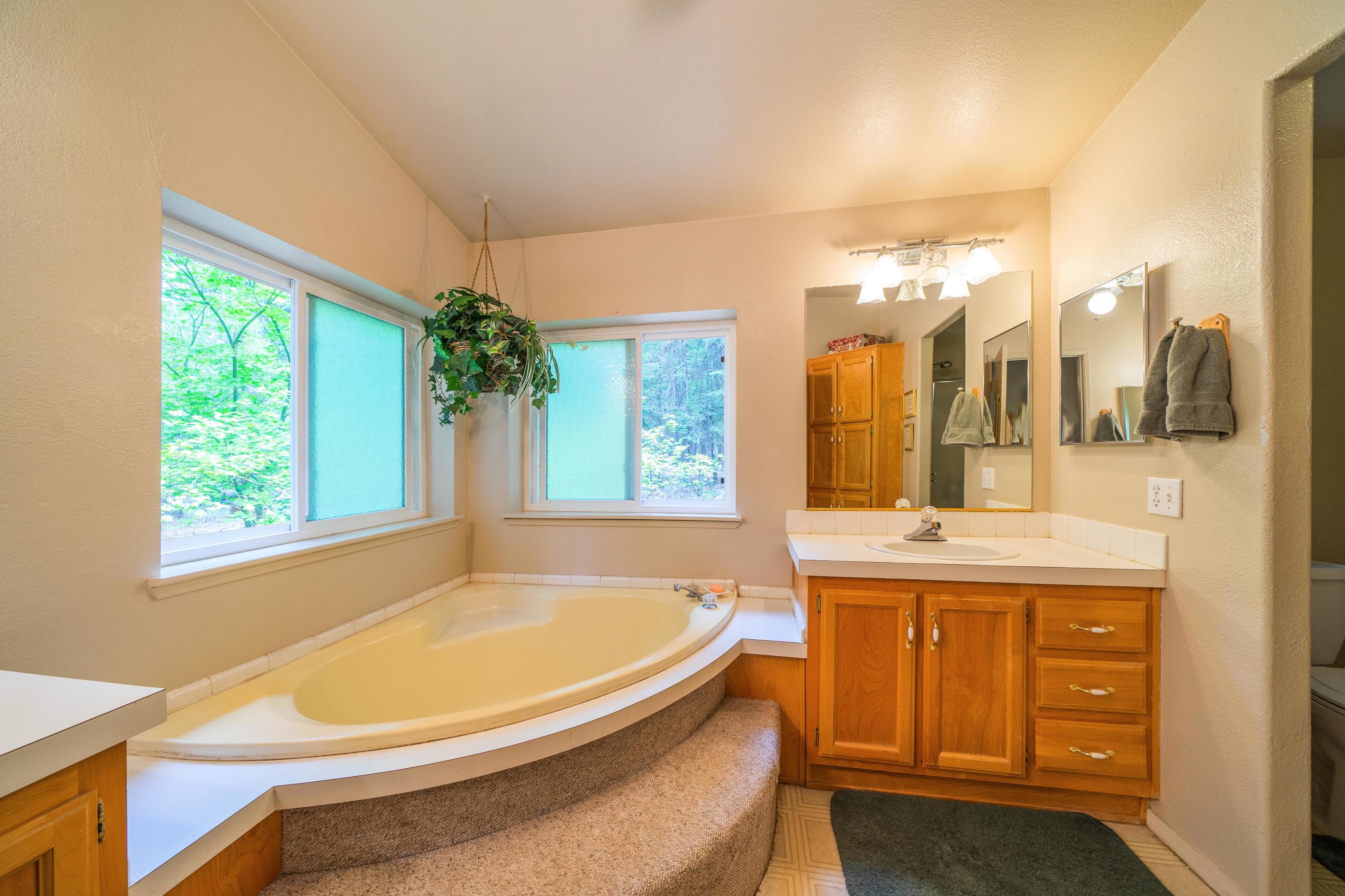 34739 Timber Ridge Road Shingletown, CA 96088 - Photo 21 of 26 a bathroom with a tub and a sink
