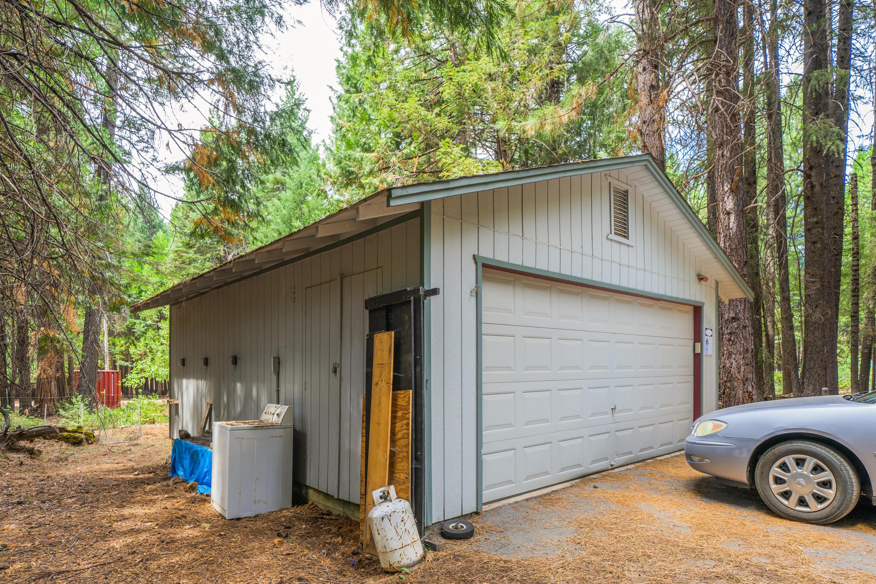 34739 Timber Ridge Road Shingletown, CA 96088 - Photo 22 of 26 a front view of a house with parking space