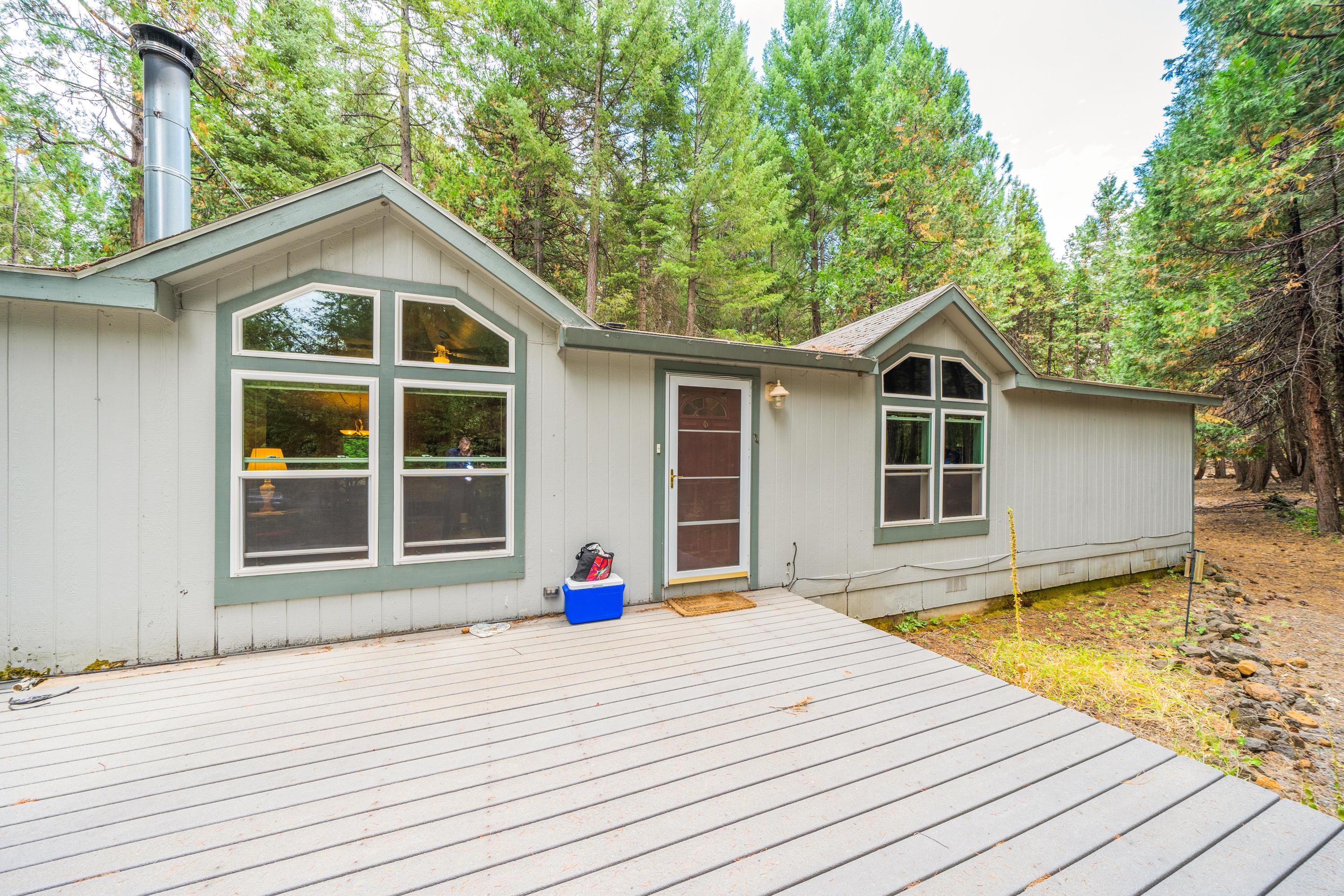 34739 Timber Ridge Road Shingletown, CA 96088 - Photo 4 of 26 a front view of a house with a yard