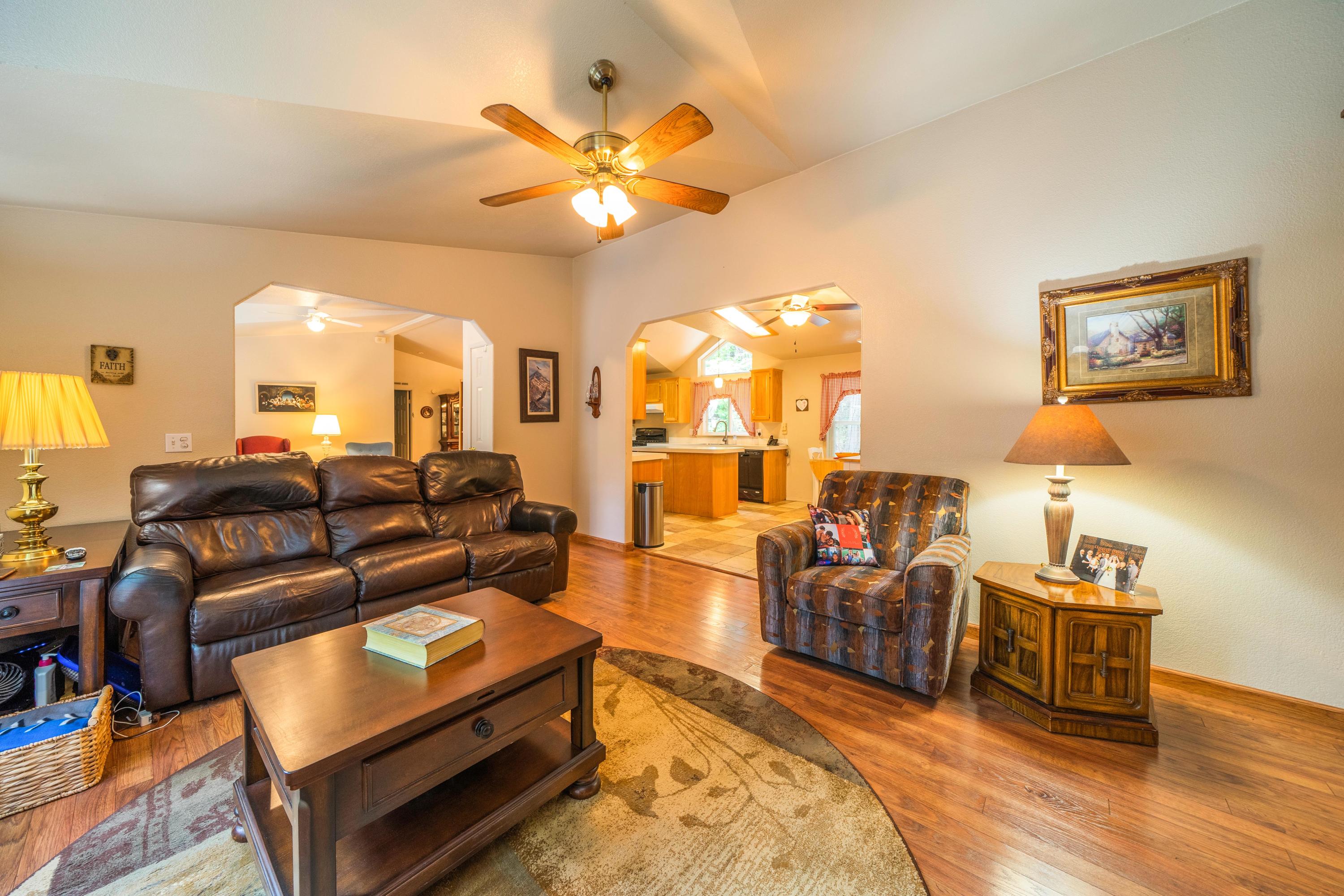 34739 Timber Ridge Road Shingletown, CA 96088 - Photo 5 of 26 a living room with furniture and a flat screen tv