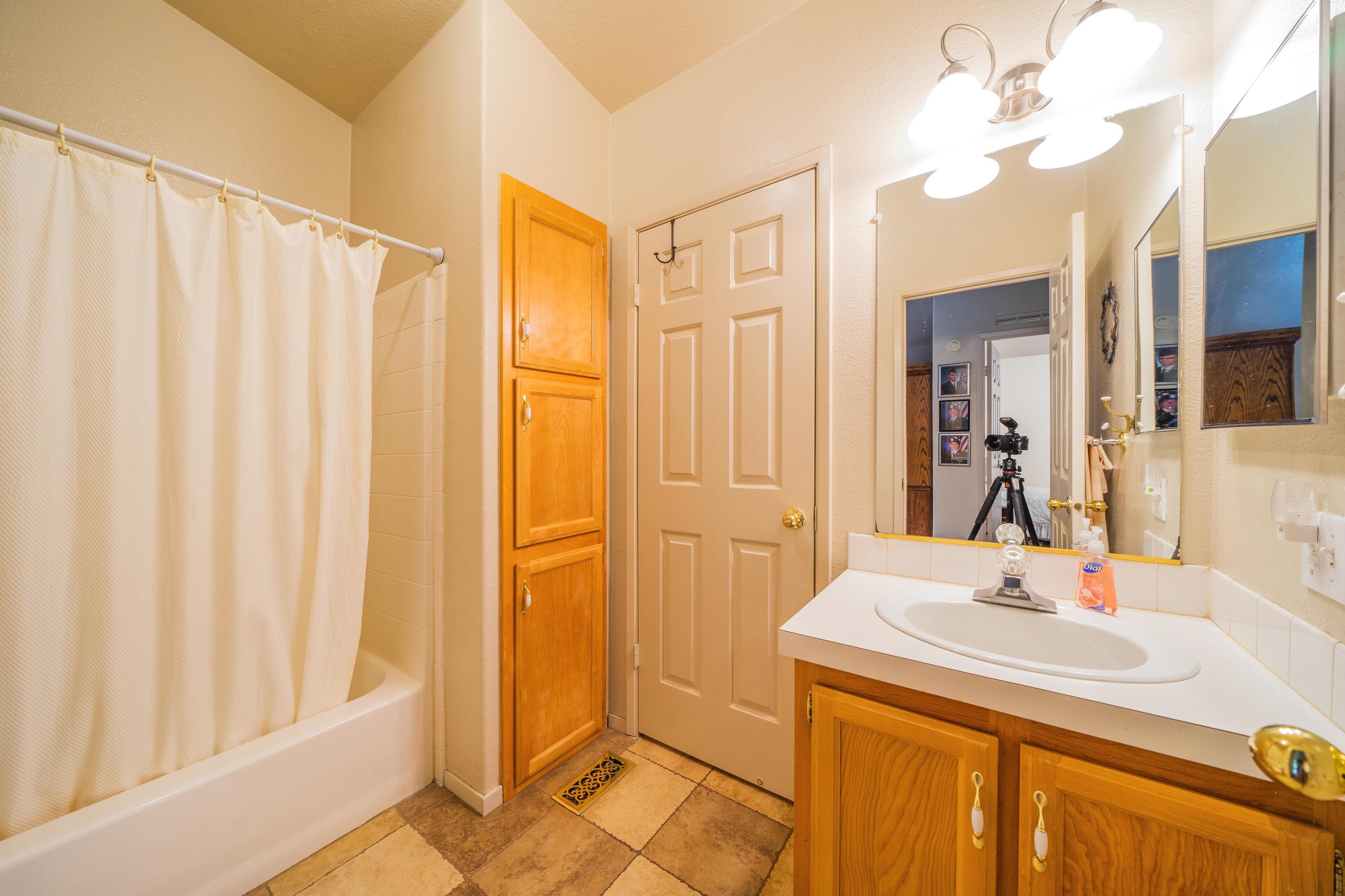34739 Timber Ridge Road Shingletown, CA 96088 - Photo 9 of 26 a bathroom with a sink tub and a mirror
