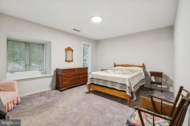 a bedroom with a bed and a table