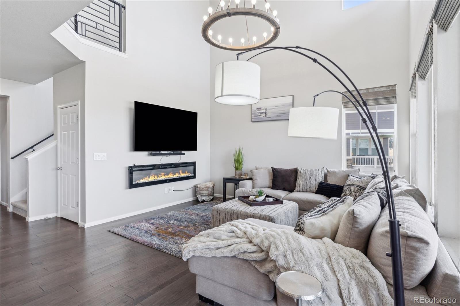 23913 East Minnow Circle Aurora, CO 80016 - Photo 17 of 49 a living room with furniture and a flat screen tv