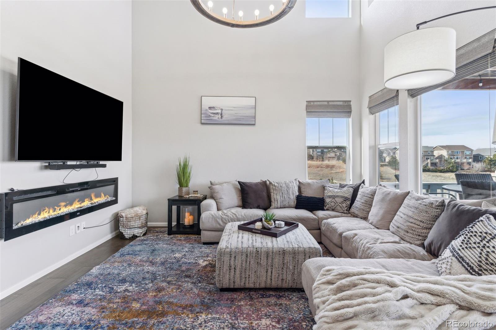 23913 East Minnow Circle Aurora, CO 80016 - Photo 18 of 49 a living room with furniture and a flat screen tv