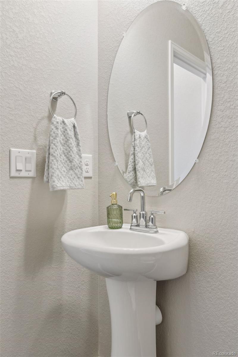 23913 East Minnow Circle Aurora, CO 80016 - Photo 25 of 49 a bathroom with a sink and a mirror