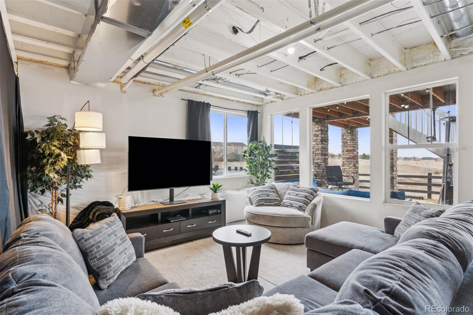 23913 East Minnow Circle Aurora, CO 80016 - Photo 42 of 49 a living room with furniture and a flat screen tv