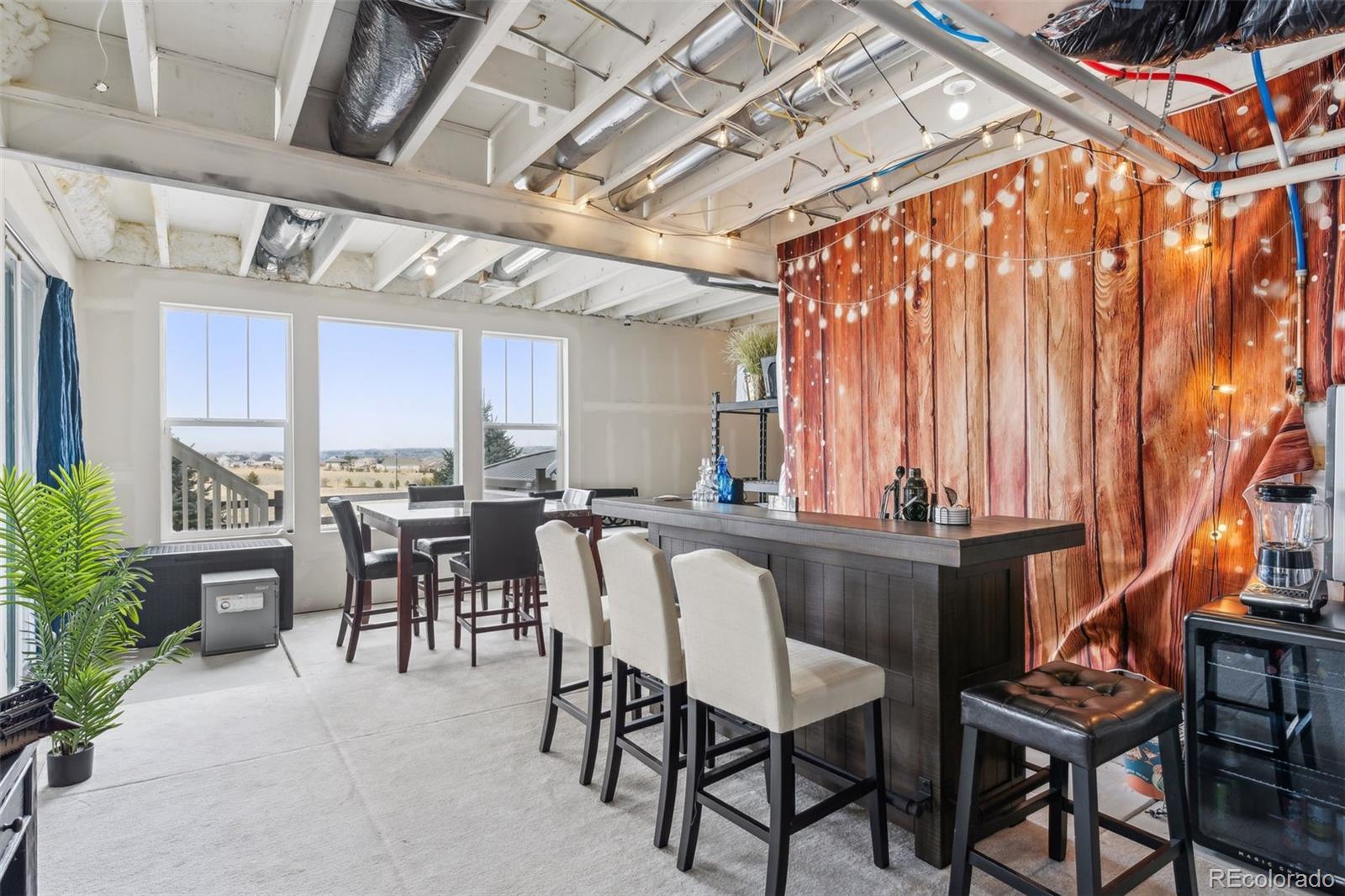 23913 East Minnow Circle Aurora, CO 80016 - Photo 43 of 49 a dining area with a table and chairs