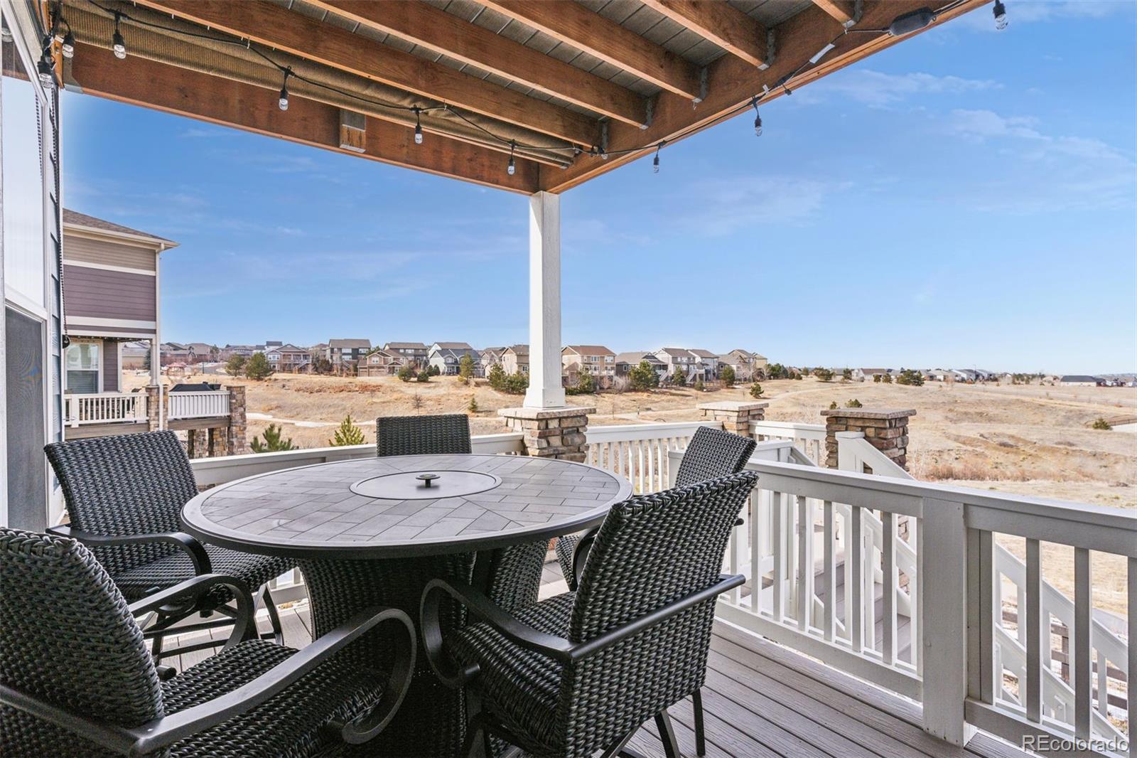 23913 East Minnow Circle Aurora, CO 80016 - Photo 5 of 49 a view of a balcony with table and chairs