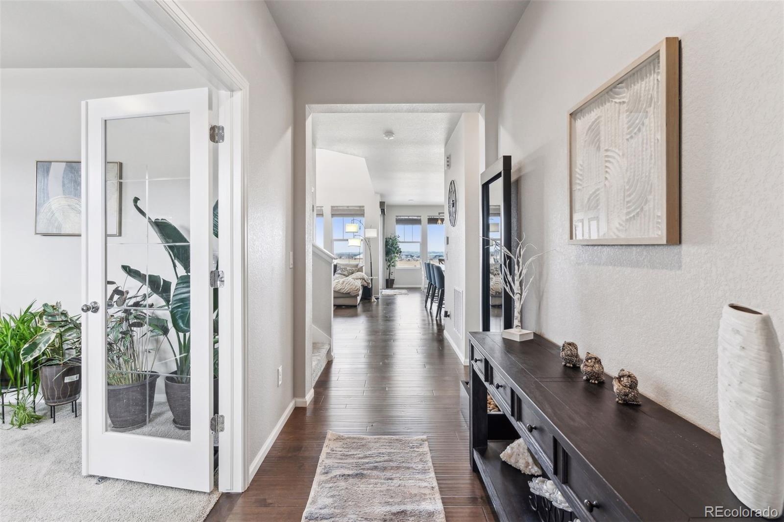 23913 East Minnow Circle Aurora, CO 80016 - Photo 7 of 49 a view of a hallway with furniture and floor to ceiling window