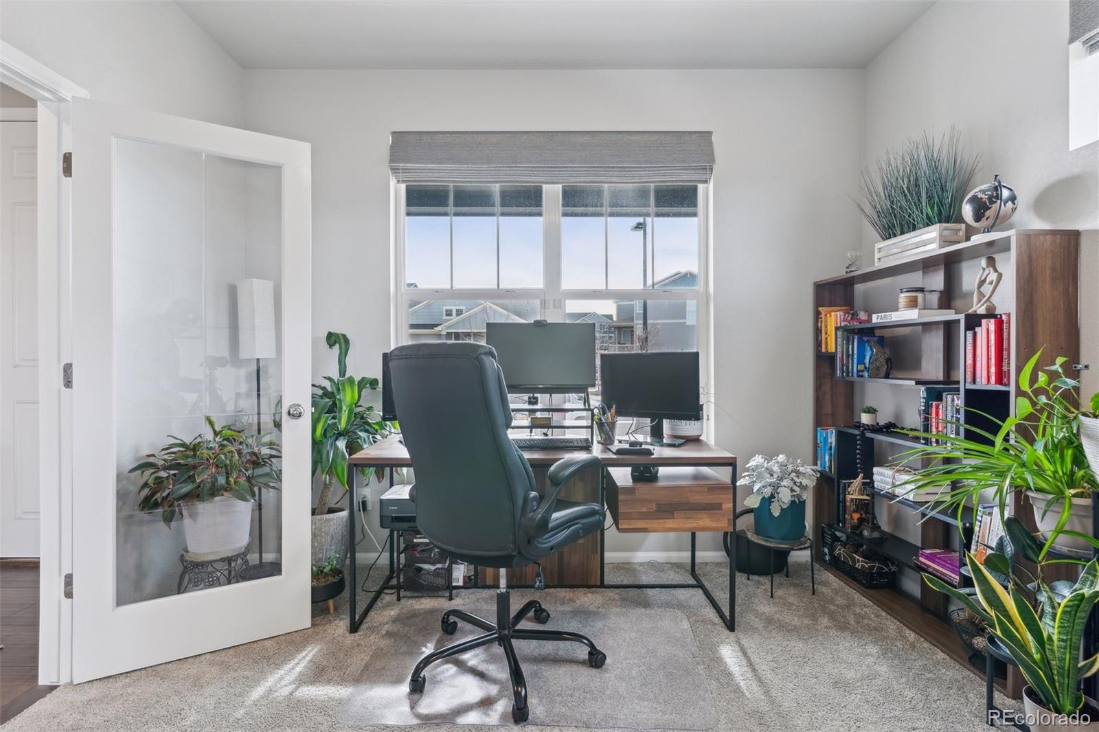 23913 East Minnow Circle Aurora, CO 80016 - Photo 9 of 49 a view of a workspace with furniture and a potted plant