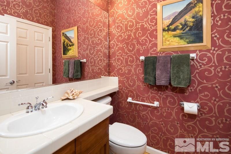 1665 Aspen Creek Road Reno, NV 89519 - Photo 14 of 25 a bathroom with a sink a toilet and mirror