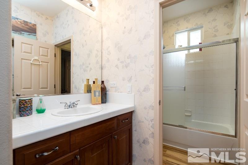 1665 Aspen Creek Road Reno, NV 89519 - Photo 16 of 25 a bathroom with a bathtub shower sink vanity and mirror