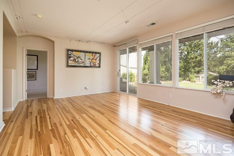 1665 Aspen Creek Road Reno, NV 89519 - Photo 17 of 25 a view of an empty room with wooden floor and a window