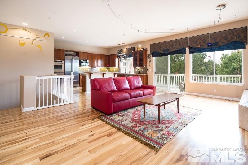 1665 Aspen Creek Road Reno, NV 89519 - Photo 2 of 25 a living room with furniture and a wooden floor