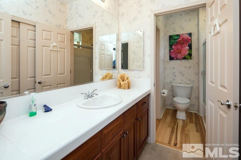 1665 Aspen Creek Road Reno, NV 89519 - Photo 25 of 25 a bathroom with a sink a toilet and shower curtain