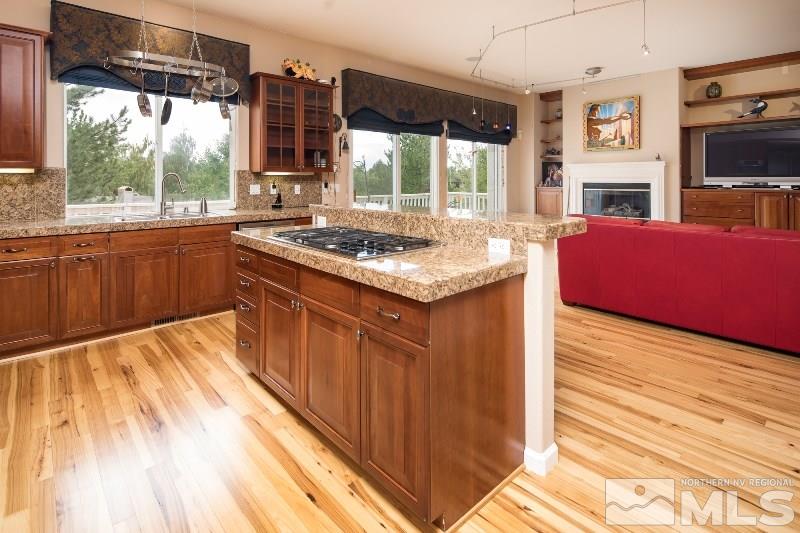 1665 Aspen Creek Road Reno, NV 89519 - Photo 4 of 25 a kitchen with stainless steel appliances granite countertop a stove and a large window