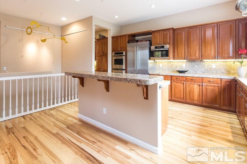 1665 Aspen Creek Road Reno, NV 89519 - Photo 5 of 25 a kitchen with stainless steel appliances granite countertop a sink refrigerator and cabinets