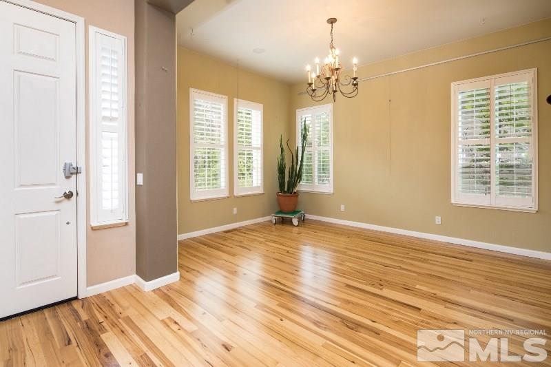 1665 Aspen Creek Road Reno, NV 89519 - Photo 7 of 25 a view of an empty room with wooden floor and a window