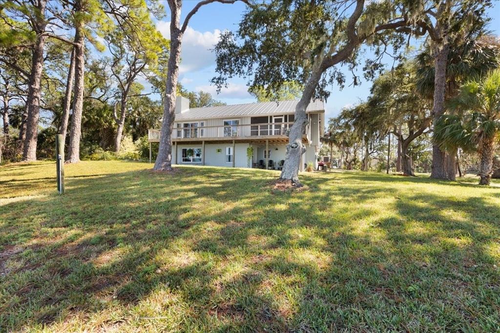 16931 Southwest 133 Street Cedar Key, FL 32625 - Photo 18 of 57 a view of swimming pool with outdoor seating and trees