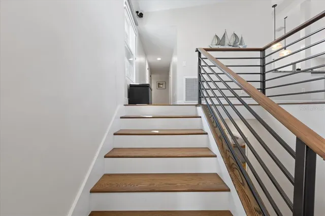 a kitchen with stainless steel appliances kitchen island granite countertop a lot of counter space and wooden floors