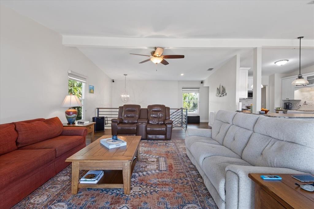 16931 Southwest 133 Street Cedar Key, FL 32625 - Photo 26 of 57 a living room with furniture a fireplace and a chandelier