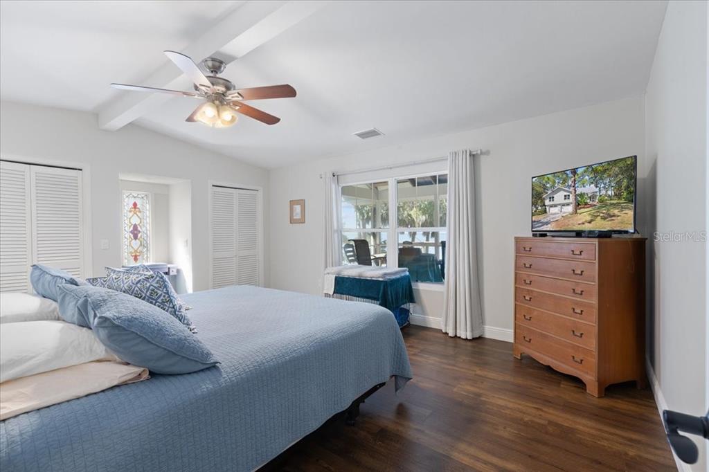 16931 Southwest 133 Street Cedar Key, FL 32625 - Photo 35 of 57 a bedroom with a bed and wooden floor