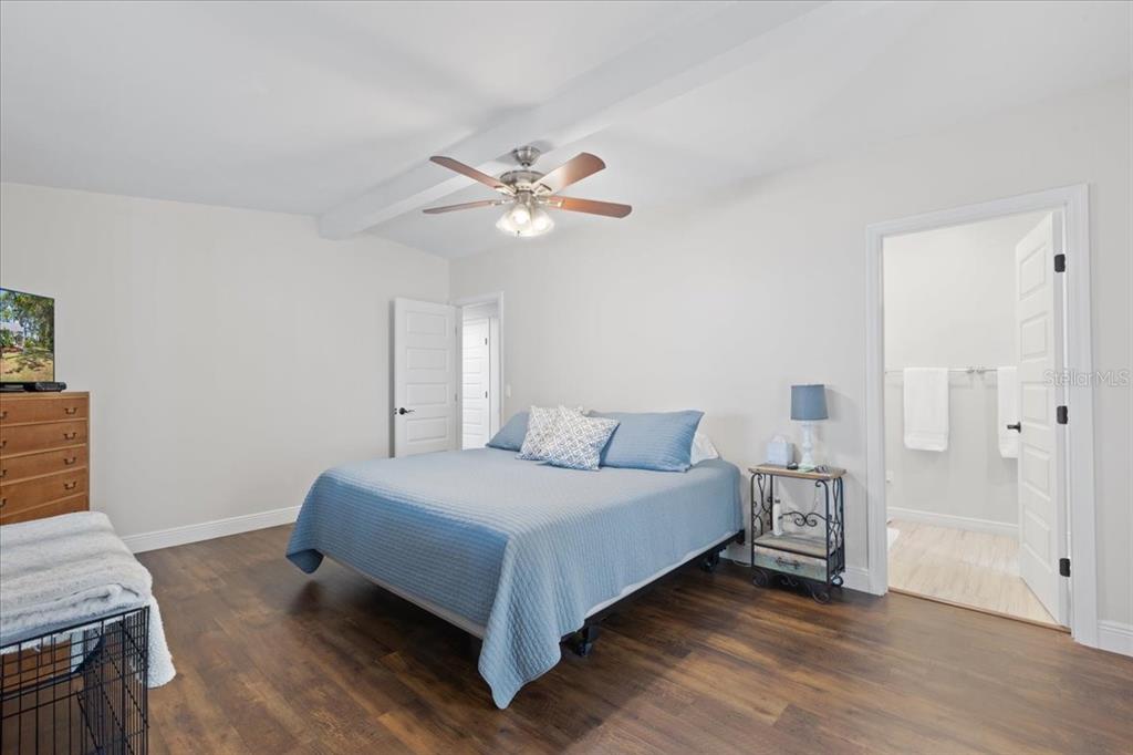 16931 Southwest 133 Street Cedar Key, FL 32625 - Photo 36 of 57 a bedroom with a bed and a chandelier