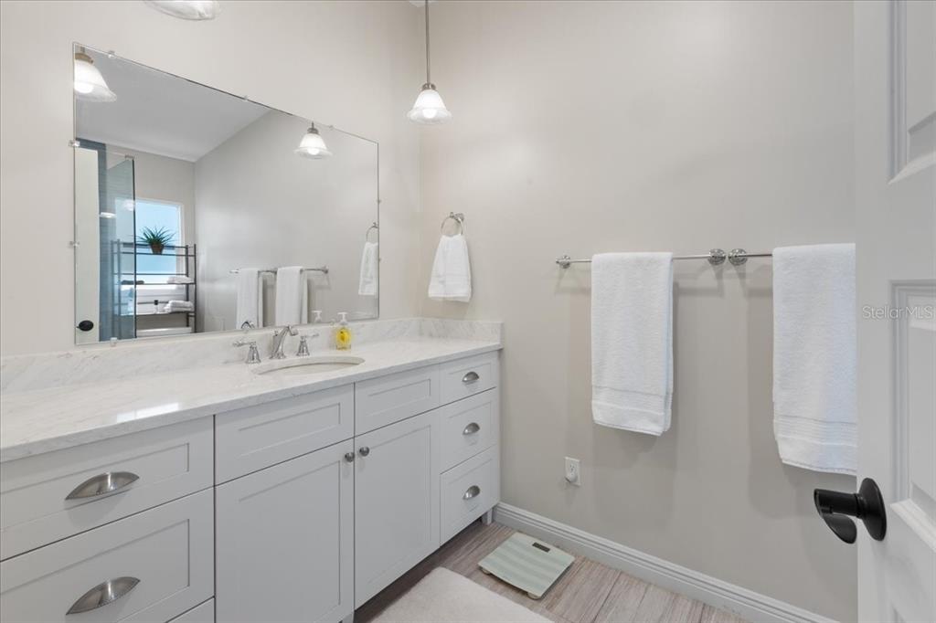 16931 Southwest 133 Street Cedar Key, FL 32625 - Photo 37 of 57 a bathroom with a double vanity sink a mirror and shower