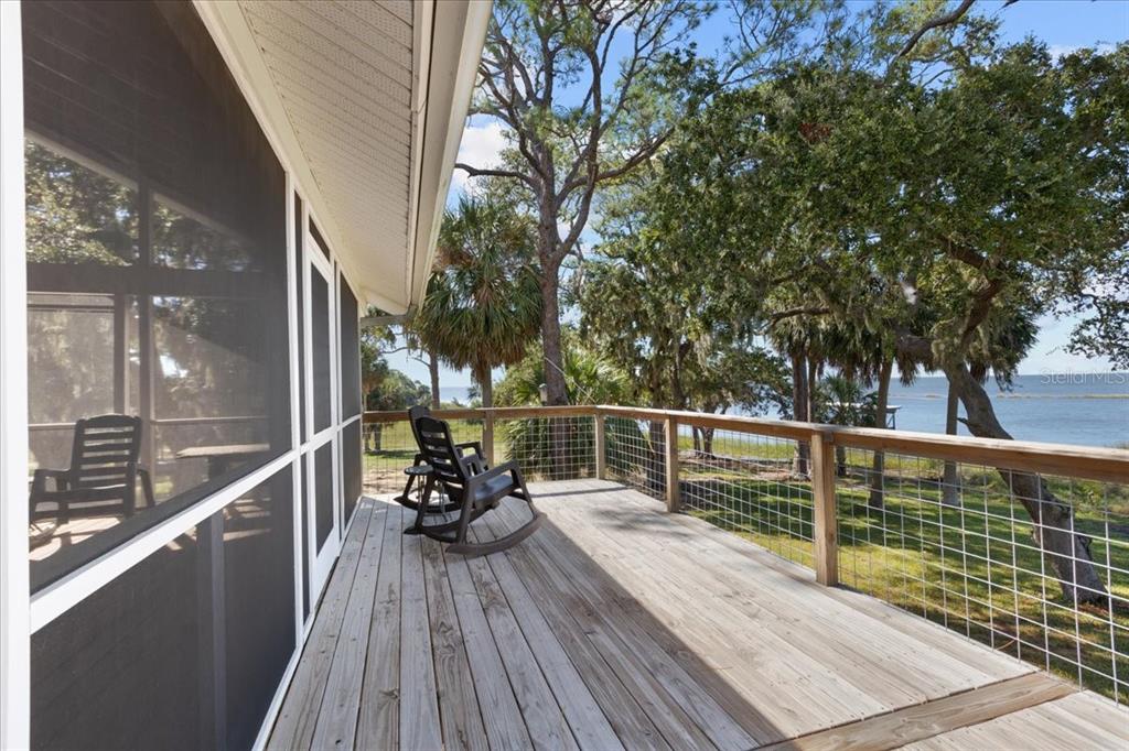 16931 Southwest 133 Street Cedar Key, FL 32625 - Photo 45 of 57 a view of balcony with two chairs and wooden floor