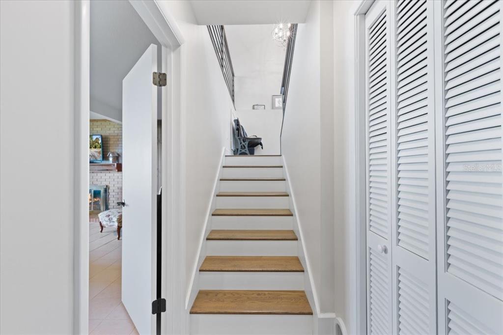 16931 Southwest 133 Street Cedar Key, FL 32625 - Photo 48 of 57 a view of staircase with wooden floor and white walls