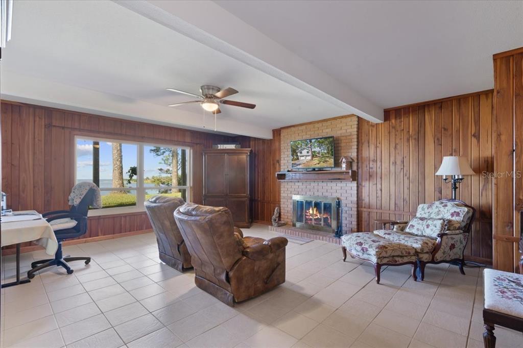 16931 Southwest 133 Street Cedar Key, FL 32625 - Photo 49 of 57 a living room with furniture and a fireplace