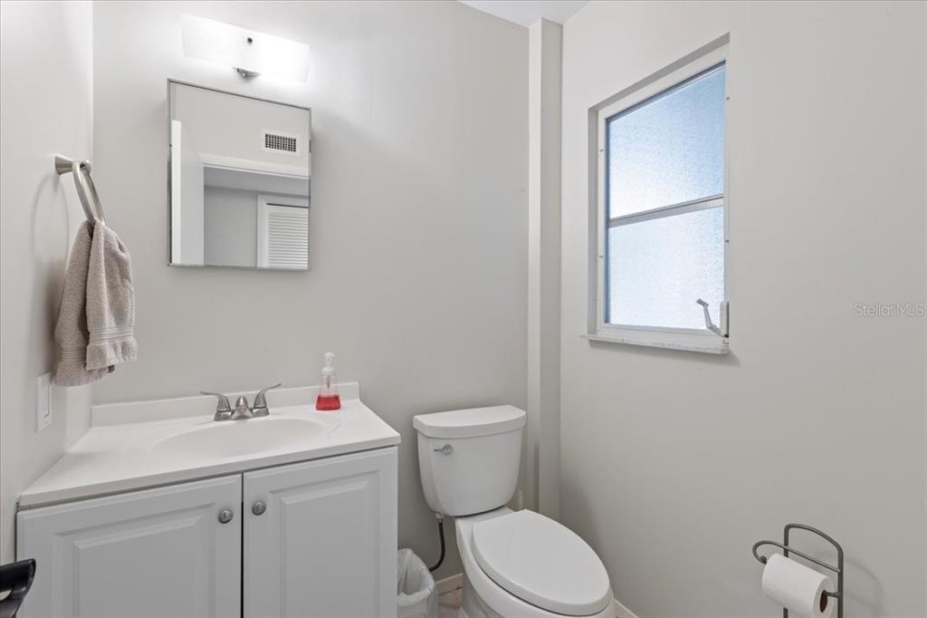 16931 Southwest 133 Street Cedar Key, FL 32625 - Photo 53 of 57 a bathroom with a toilet sink vanity and mirror
