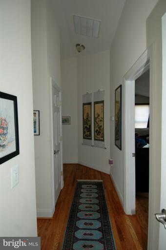 108 Farmington Road West Accokeek, MD 20607 - Photo 20 of 30 a view of a hallway with wooden floor and staircase