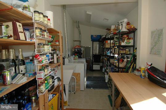 108 Farmington Road West Accokeek, MD 20607 - Photo 25 of 30 a storage room on a table and a wine shelf