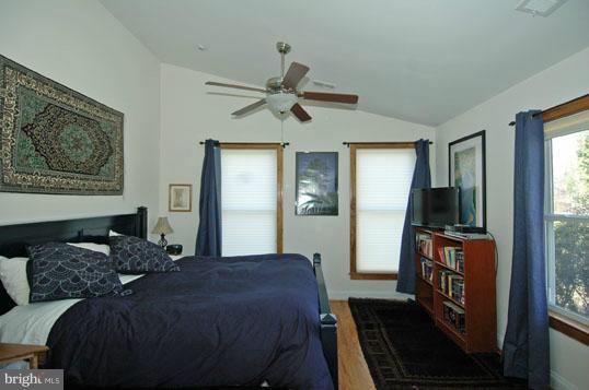 108 Farmington Road West Accokeek, MD 20607 - Photo 8 of 30 a bedroom with a large bed and a chandelier