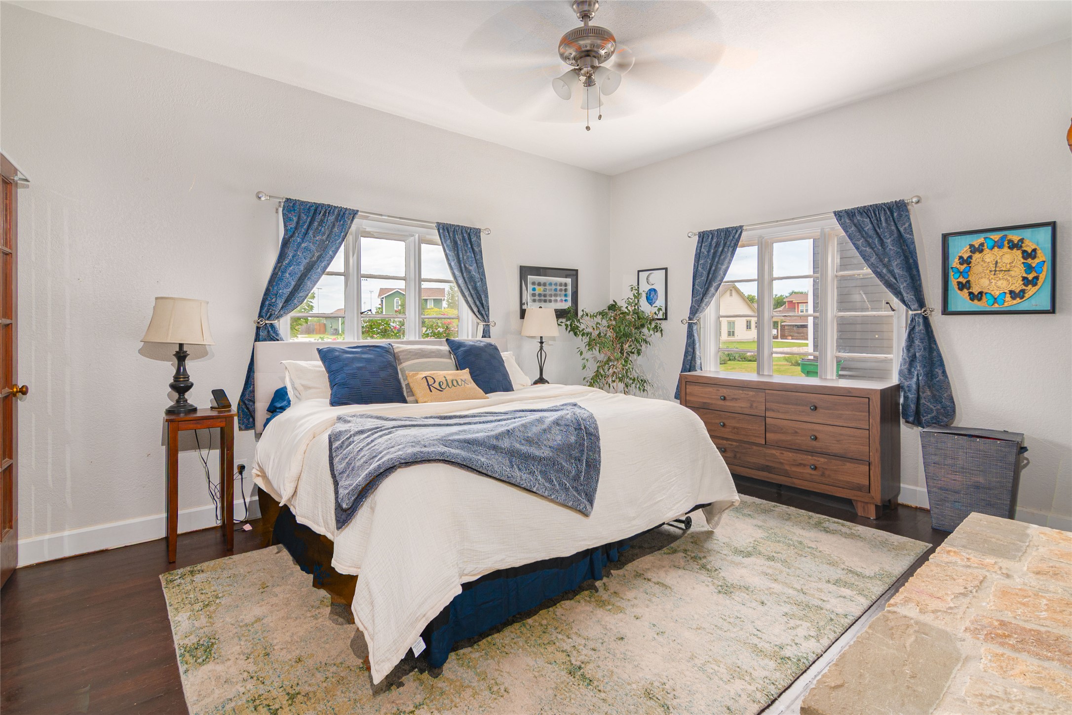 204 Prim Rose Road Blanco, TX 78606 - Photo 17 of 40 Rich hardwood flooring and classic multi-pane windows anchor this welcoming bedroom space.