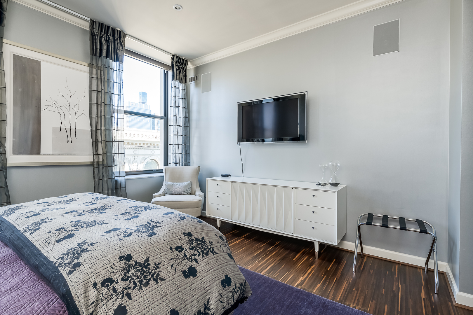 310 South Michigan Avenue, Unit 1900 Chicago, IL 60604 - Photo 12 of 25 a bedroom with a bed and a flat screen tv