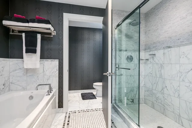 a bathroom with a bathtub and a shower