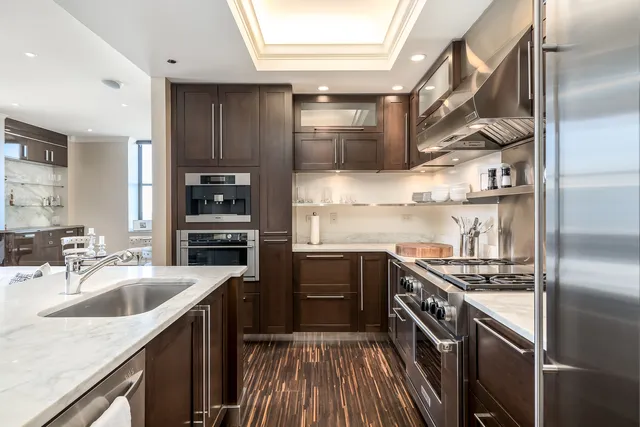 a kitchen with stainless steel appliances granite countertop a sink stove and refrigerator
