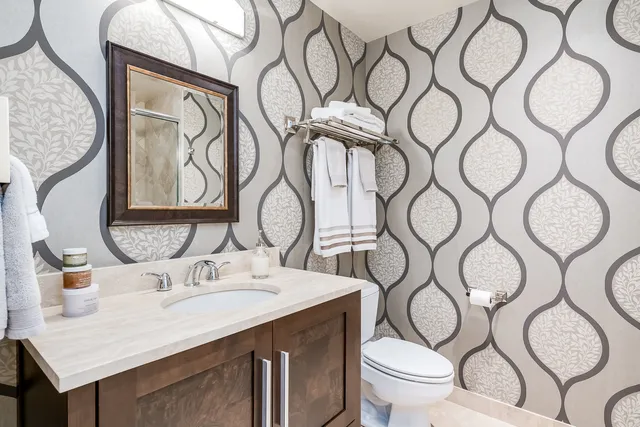 a bathroom with a toilet sink and mirror