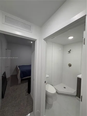 a bathroom with a toilet a sink and shower