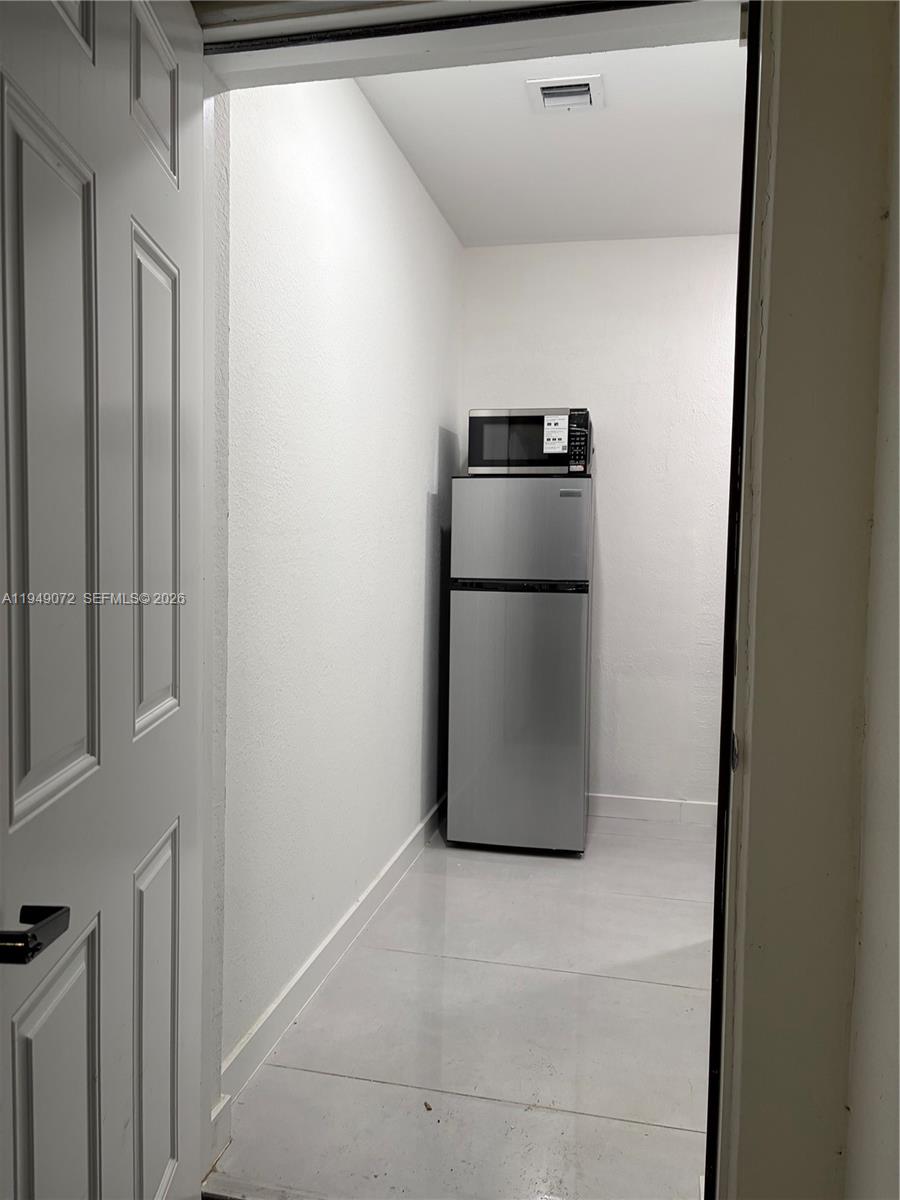 26126 Southwest 146th Avenue, Unit B Homestead, FL 33033 - Photo 7 of 7 a utility room with wooden floor washer and dryer
