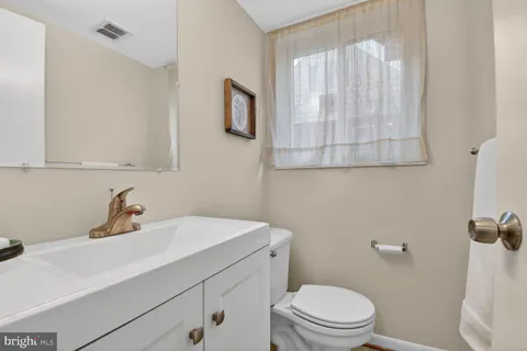 a bathroom with a sink a mirror and a toilet