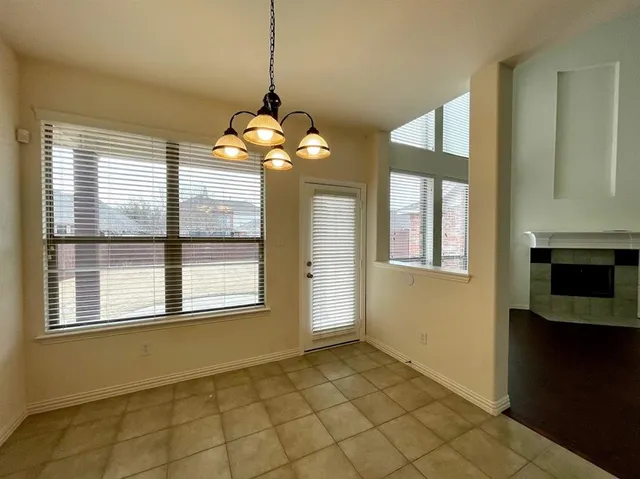a view of a livingroom with a chandelier fan and windows